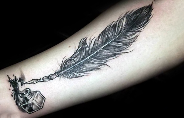 Feather with a pen nib tattoo