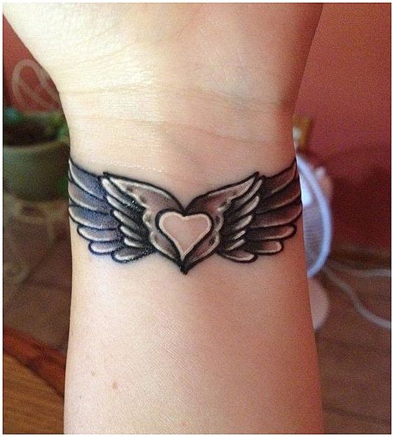 heart tattoo with wings on wrist