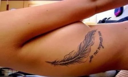 Rib Feather tattoo