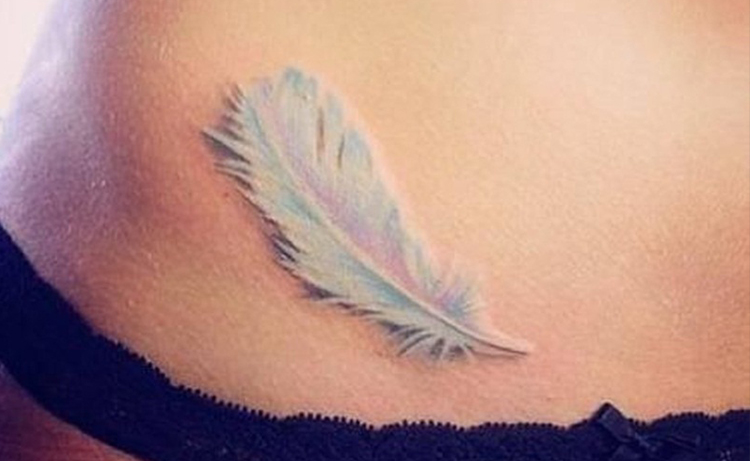 white feather in your belly button Tattoo