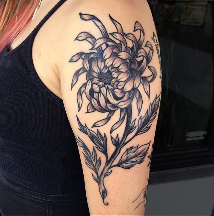 Flower tattoo on the back of the left arm