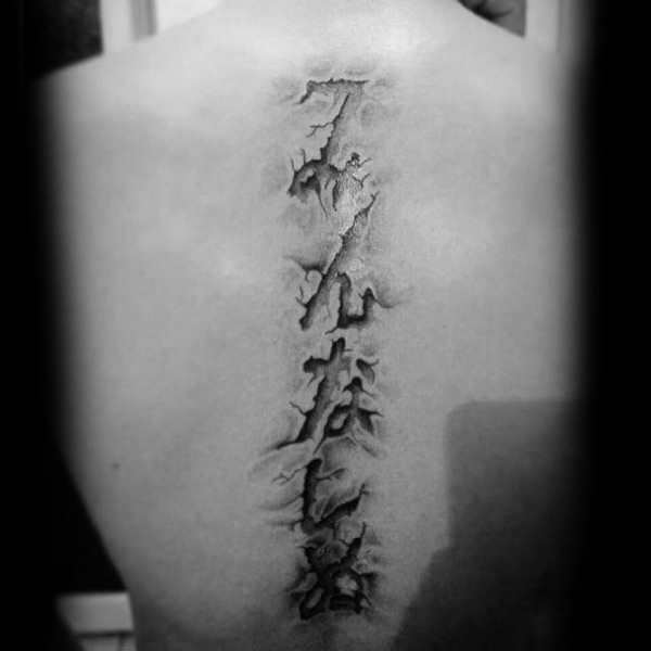 3d torn skin spine lettering tattoos for guys