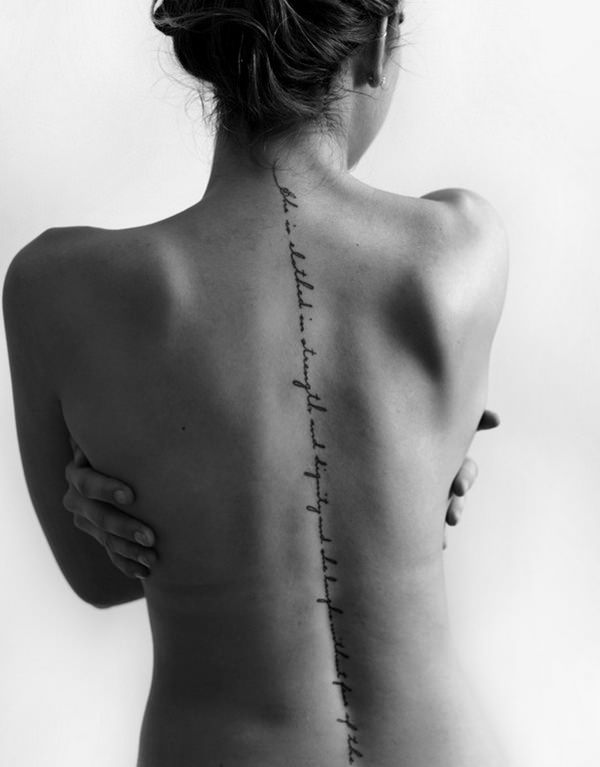 Caligraphy spine tattoo