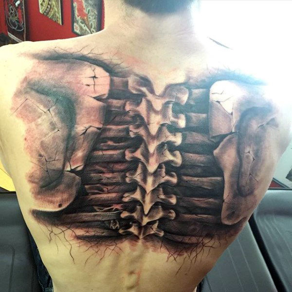 Man with black ink shaded realistic spine tattoo on back
