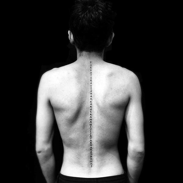 Mens lettering middle of back spine tattoo