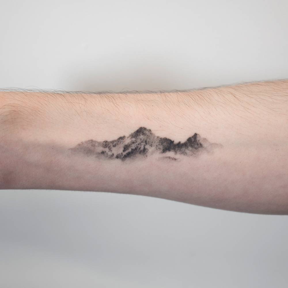 Small Mountain tattoo designs on wrist