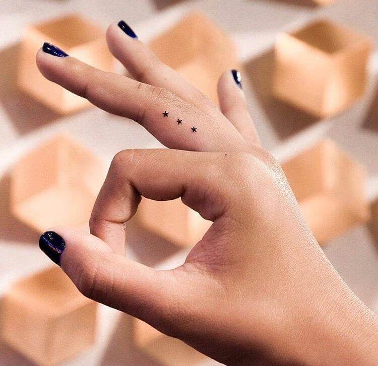 Three Small Stars Tattoo Designs on finger