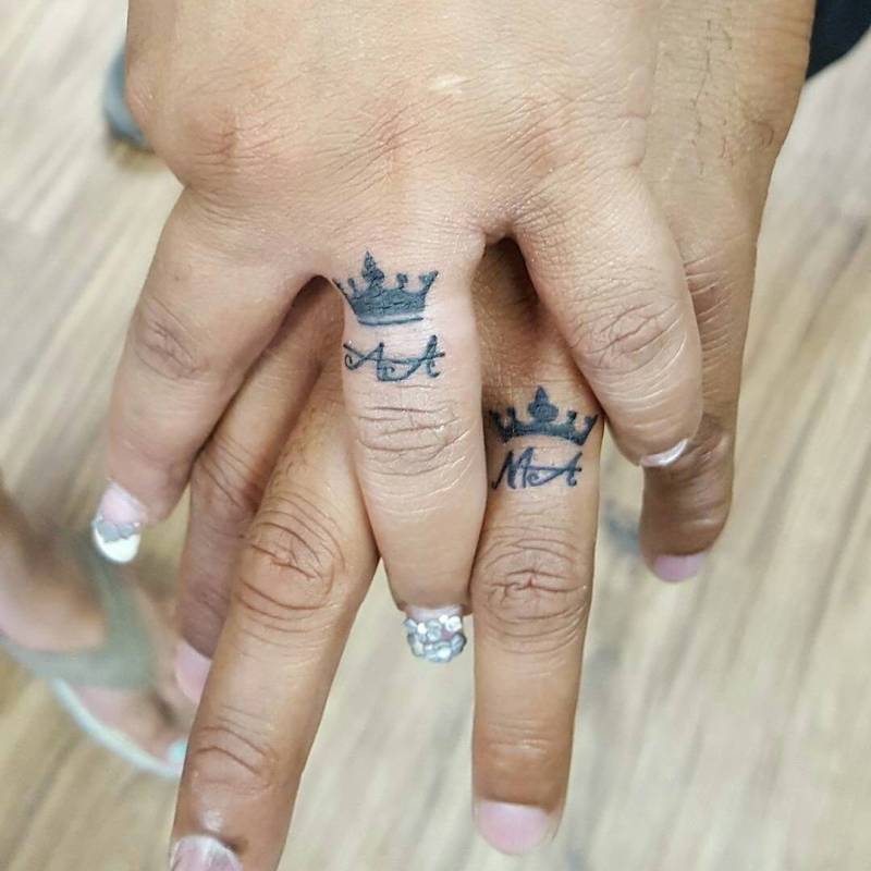 Name tattoo in a ring with crown