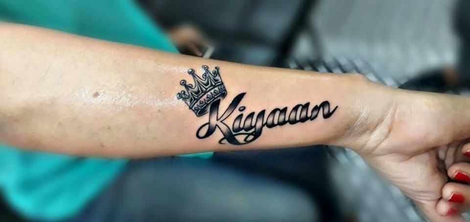 Name tattoo with a crown