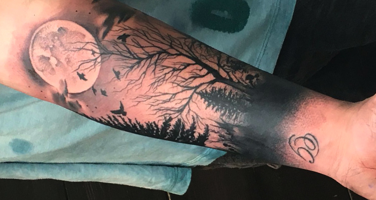 crescent moon encompassing trees on your hand tattoo