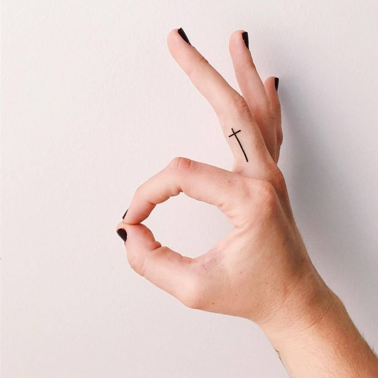 Tiny cross finger tattoos