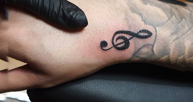 music symbol on your hand tattoo