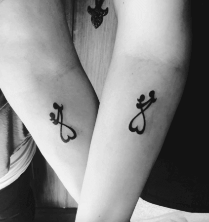 Mother daughter symbol tattoo on arm