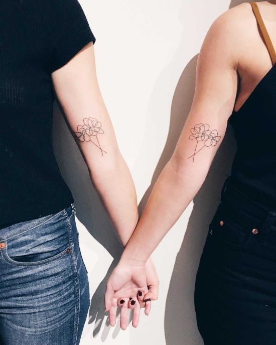 Matching minimalist flowers tattoos