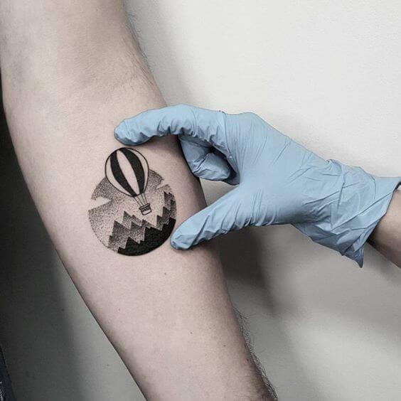 Minimalist air ballon tattoo designs on arm