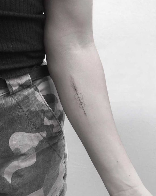 Tiny Arrow tattoo on arm
