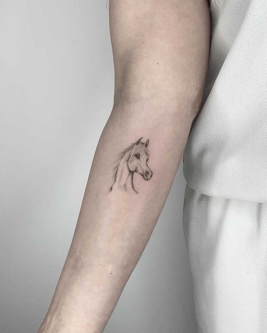 small horse tattoo on arm