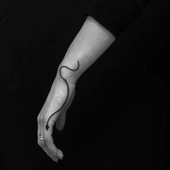Minimalist thin snake Tattoo designs on wrist
