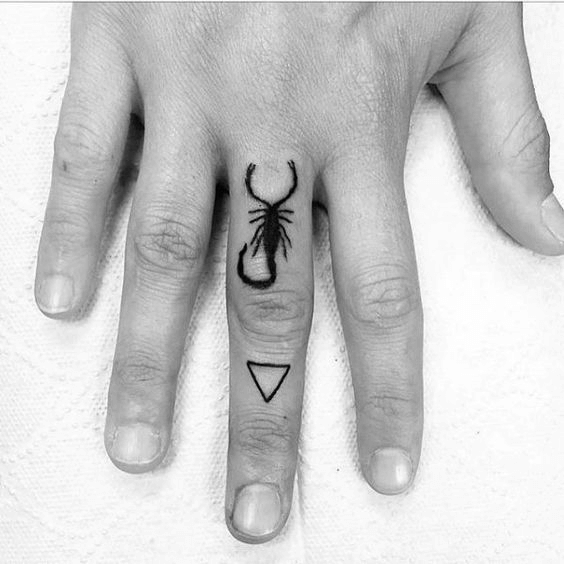 Small Scorpio tatto on finger