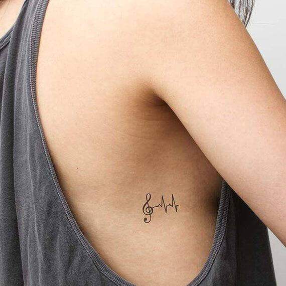 Small Tattoo on girl ribcage