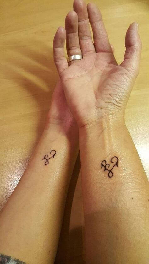 amazing mother daughter symbol tattoo on hand