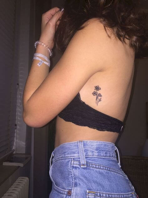 tiny flower tattoo on girl