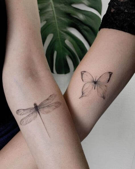 Dragonfly and butterfly tattoo on arm