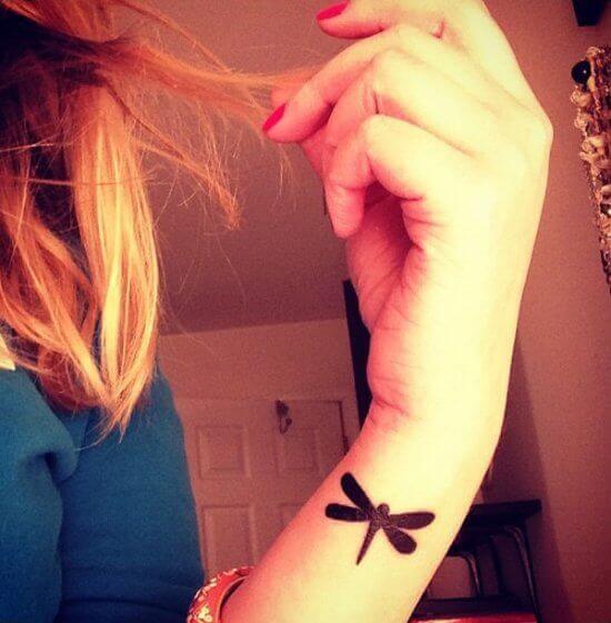 Small Black Dragonfly wrist tattoo girl