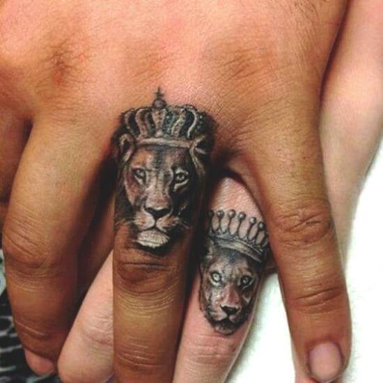 Tiny lion with crown tattoo on finger