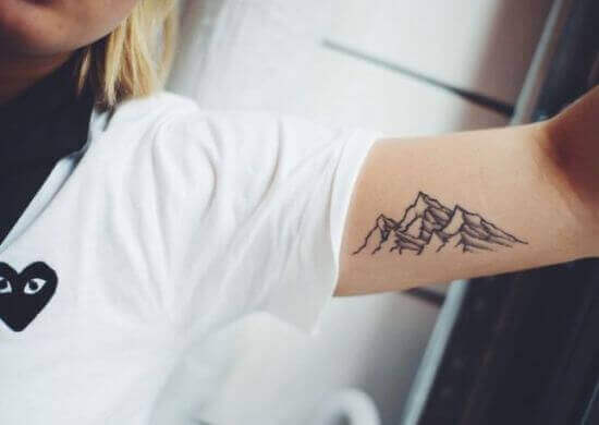 Mountain with three peaks tattoo ideas on girl arm