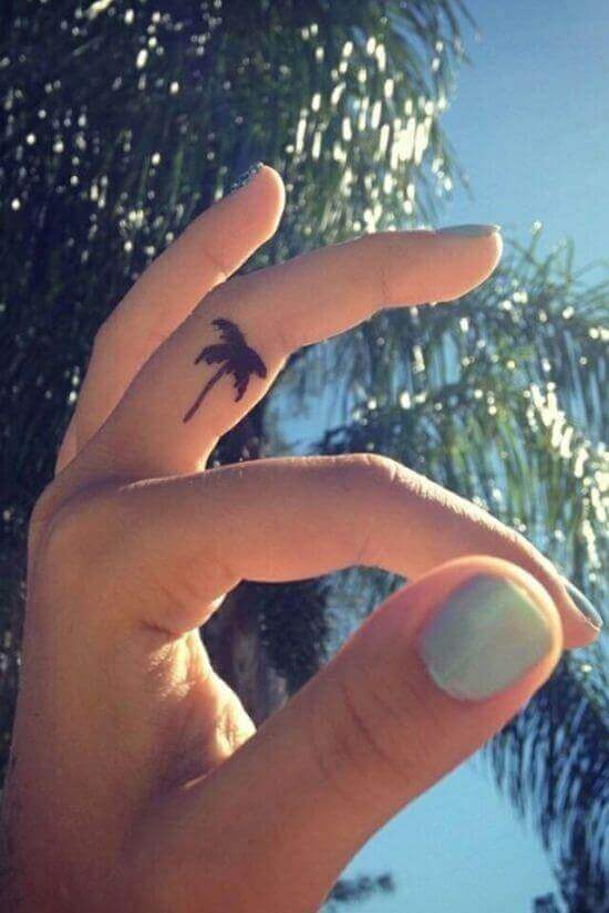 Tiny Palm tree tattoos on finger