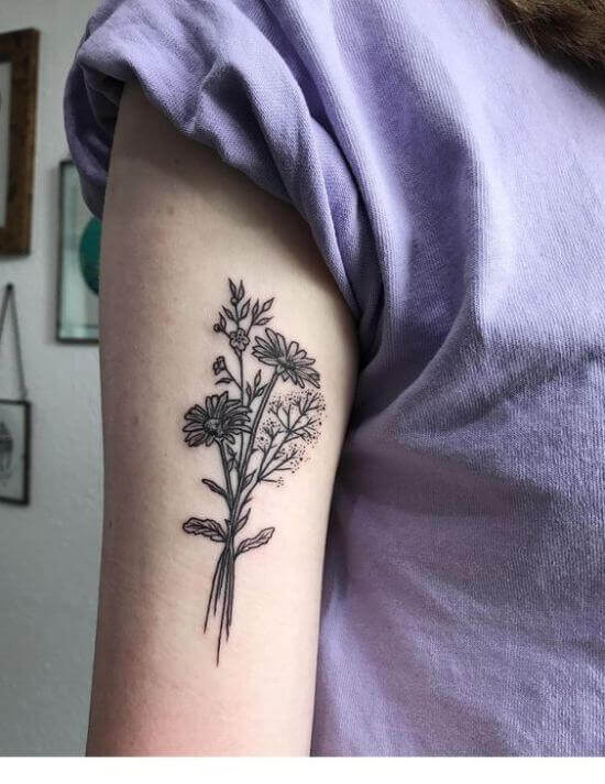 black flower tattoo on girl forearm