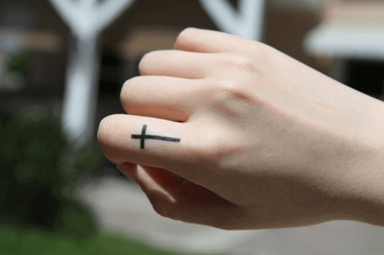 Small Cross tattoo on Finger