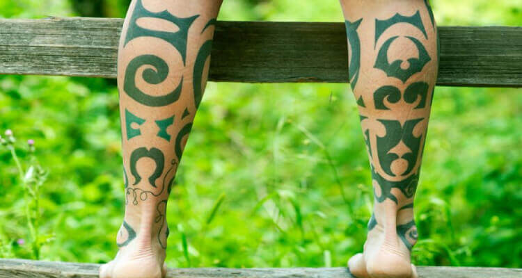 green ink leg tattoo