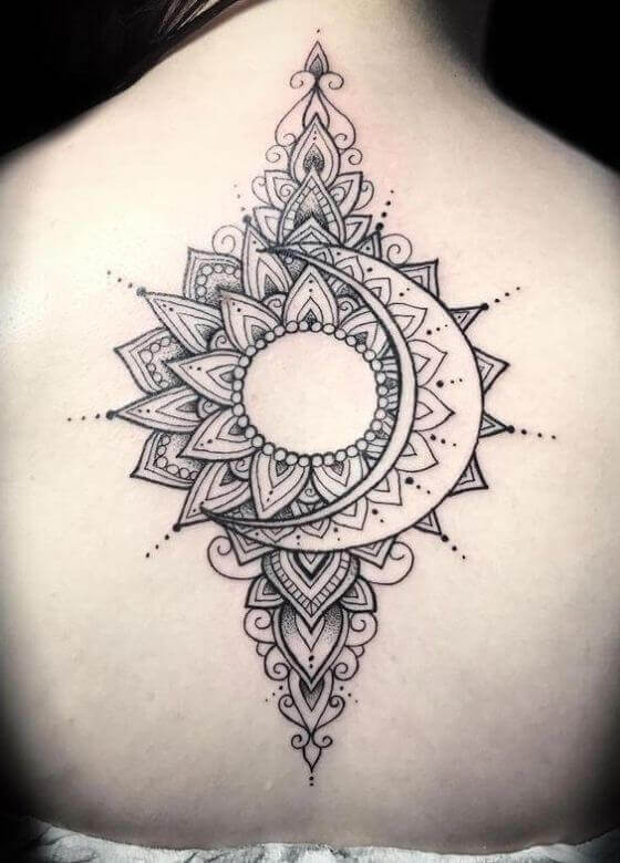 Black half sun and moon tattoo on upper back for women