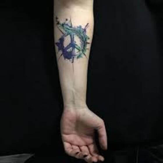 Watercolor peace tattoo with bird on arm