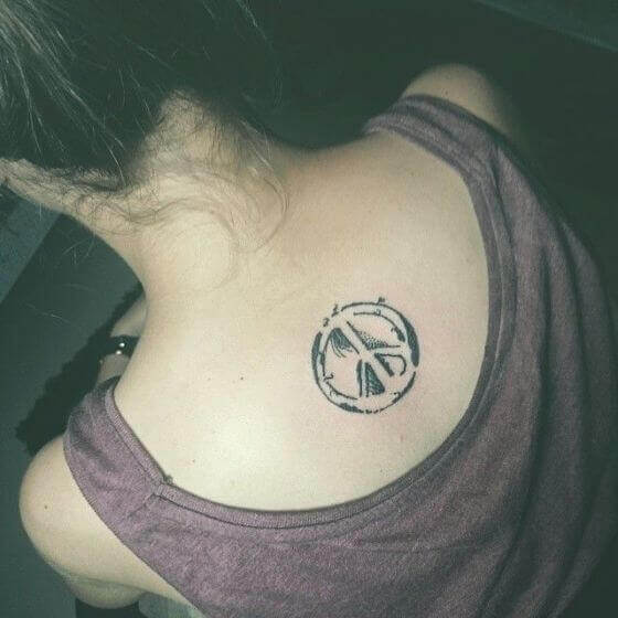 peace sign tattoo on back