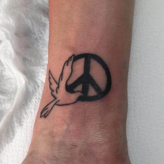peace tattoo with bird