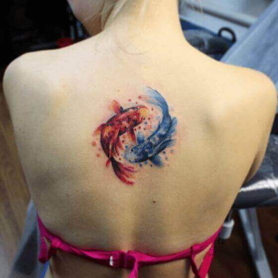 Two Koi Fish Tattoos on girl's back side