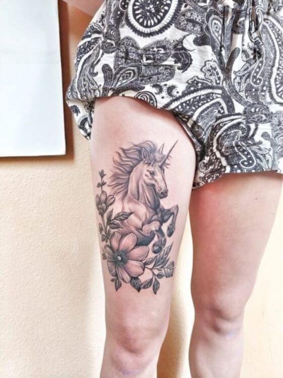 best Unicorn with Flowers tattoo on girl thigh