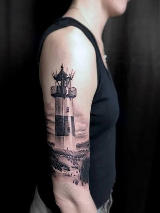 lighthouse tattoo on man shoulder