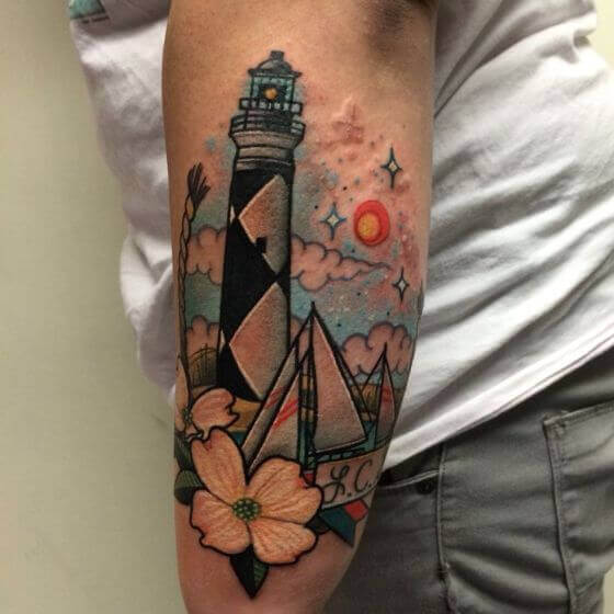 Traditional style lighthouse and compass tattoo on the