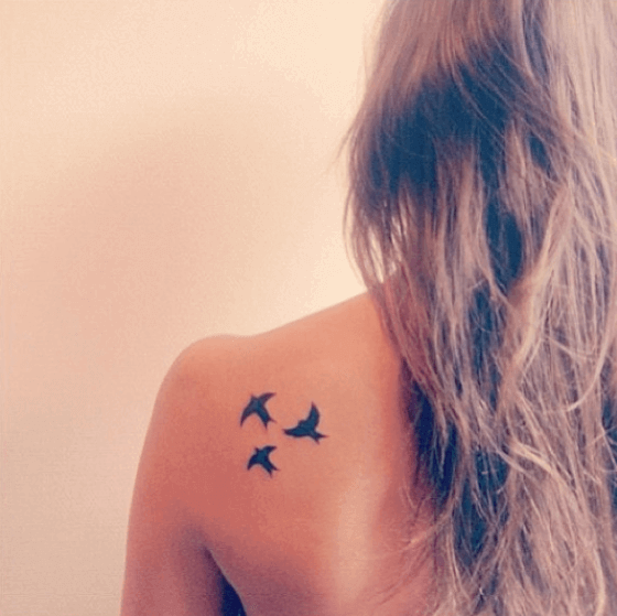 Flying Bird tattoo on female shoulder