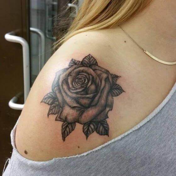 female Black rose tattoo on shoulder