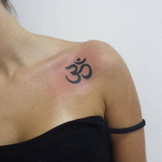 om Symbol tattoo on female shoulder