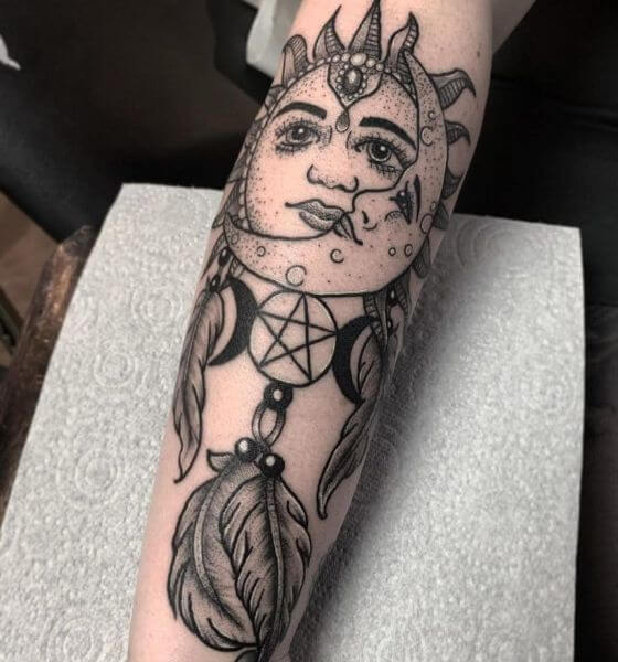 Dream catcher tattoo with sun on forearm