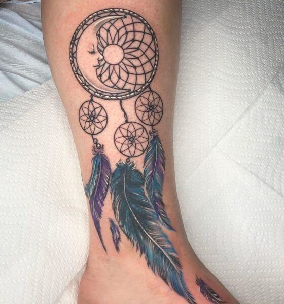 Dream catcher with floral tattoo on leg