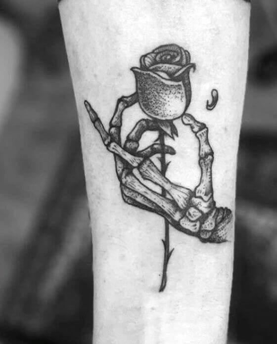 A Skeleton Hand Holding a Rose Tattoo