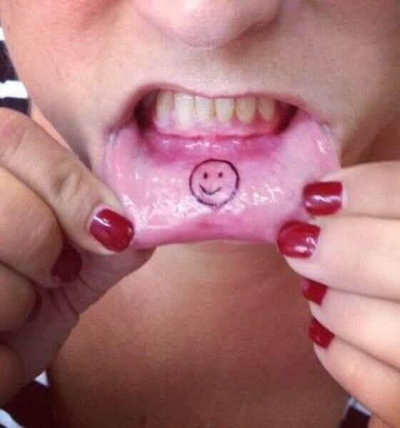 Smiley symbol tattoo on Lips