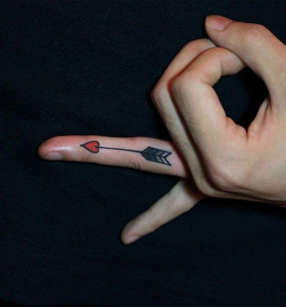 Arrow tattoo on finger